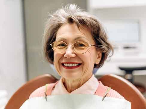an older patient with dentures smiling