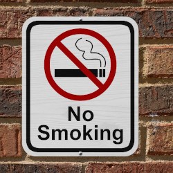 No smoking sign on a red brick wall